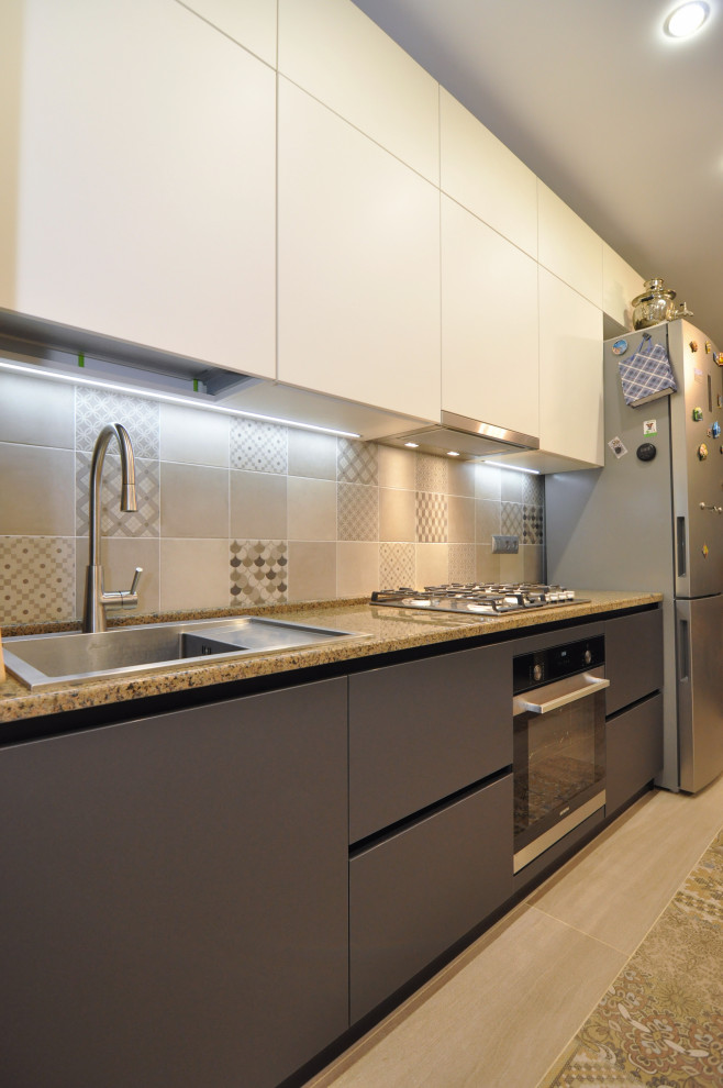Medium sized contemporary grey and white l-shaped kitchen/diner in Other with a built-in sink, flat-panel cabinets, grey cabinets, granite worktops, beige splashback, ceramic splashback, black appliances, ceramic flooring, no island, beige floors, brown worktops and a coffered ceiling.