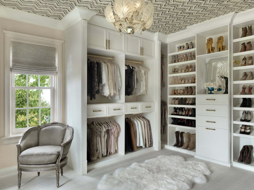 Inspiration for a large transitional women's walk-in wardrobe in St Louis with white cabinets, carpet, wallpaper, open cabinets and grey floor.