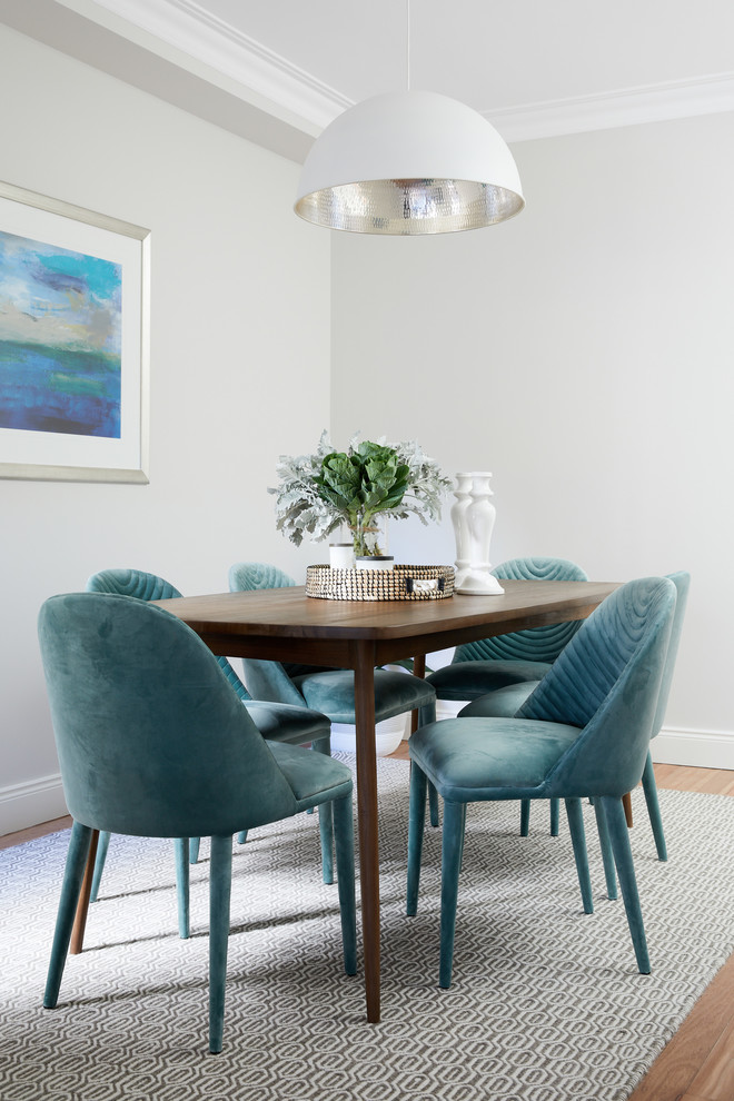 Design ideas for a beach style dining room in Sydney with grey walls, medium hardwood floors and beige floor.