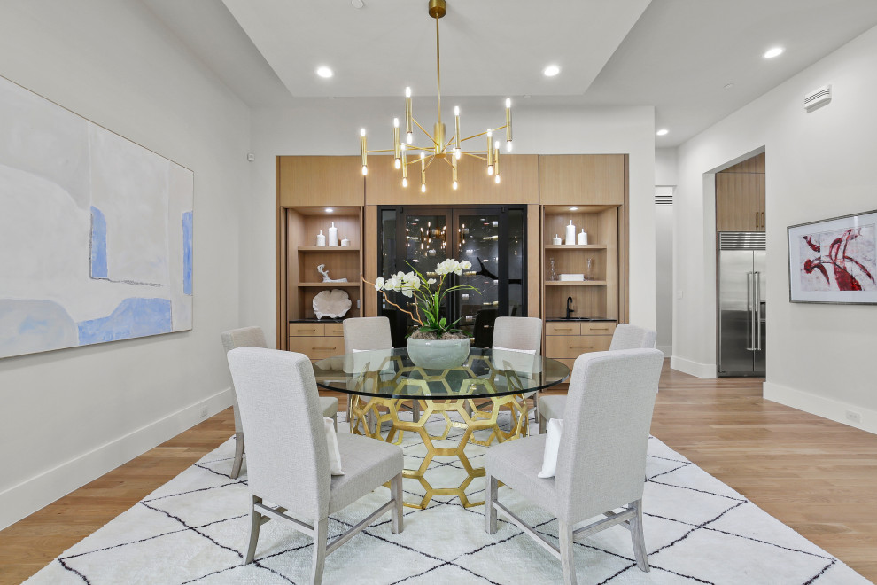 Inspiration for a large modern kitchen/dining combo in Dallas with white walls, light hardwood floors, no fireplace and yellow floor.