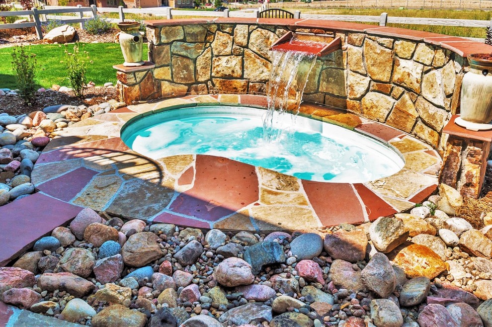 Inspiration for a small contemporary backyard garden in Denver with with waterfall and natural stone pavers.