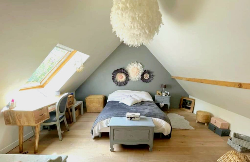 Photo of a large traditional mezzanine and grey and white bedroom in Paris with grey walls, light hardwood flooring and beige floors.