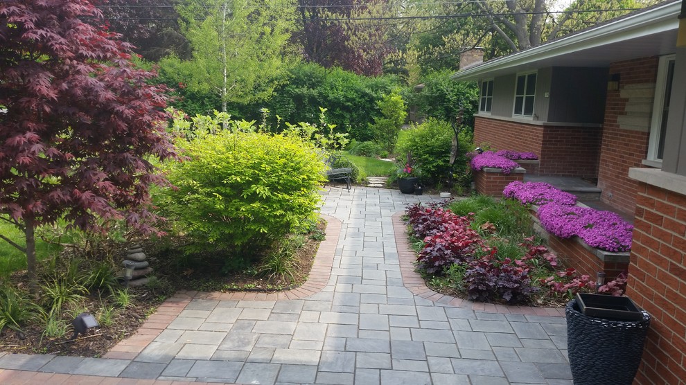 Design ideas for a small modern front yard partial sun garden for summer in Chicago with a garden path and natural stone pavers.