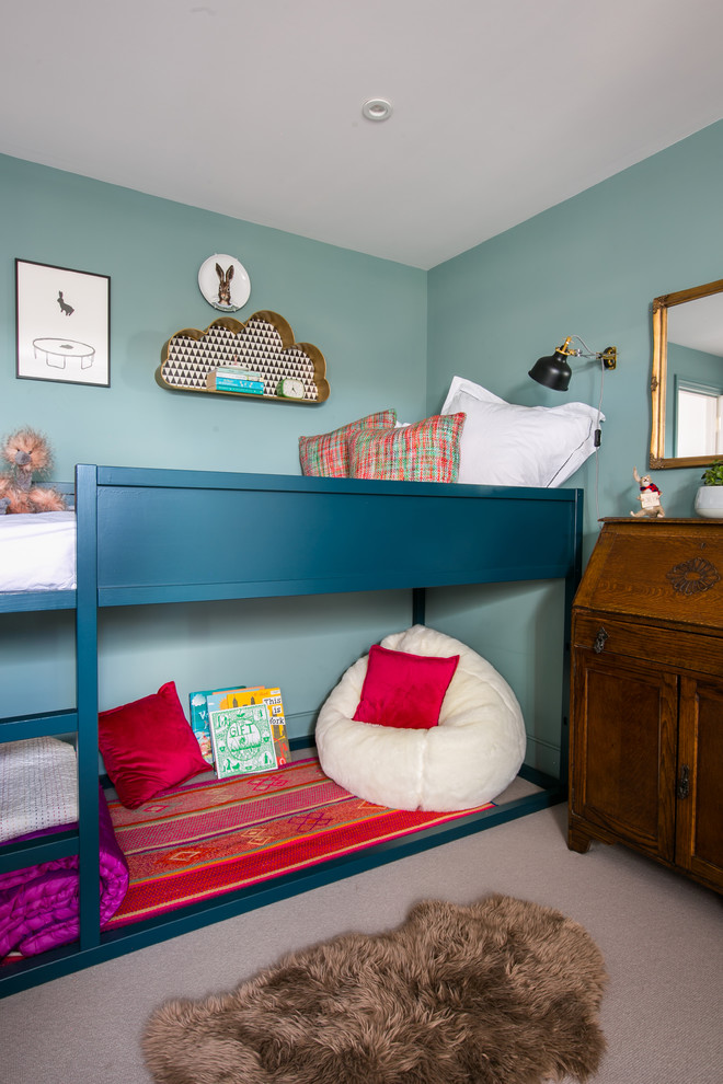 Inspiration for a mid-sized transitional gender-neutral kids' bedroom in London with blue walls and carpet.