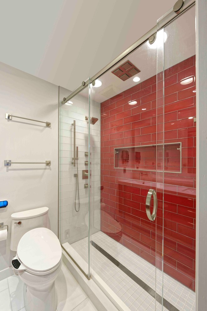 Photo of a small modern kids bathroom in DC Metro with flat-panel cabinets, red cabinets, an alcove shower, a one-piece toilet, red tile, subway tile, white walls, porcelain floors, an undermount sink and engineered quartz benchtops.