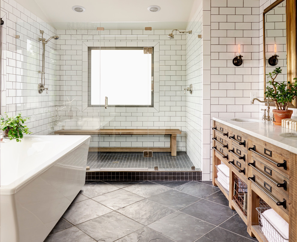 Design ideas for a large country master bathroom in Charlotte with light wood cabinets, a freestanding tub, a double shower, subway tile, white walls, slate floors, an undermount sink, a hinged shower door, a shower seat and flat-panel cabinets.