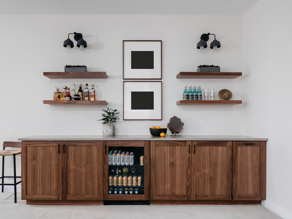 This is an example of a mid-sized midcentury single-wall home bar in Chicago with no sink, shaker cabinets, medium wood cabinets, beige floor and grey benchtop.