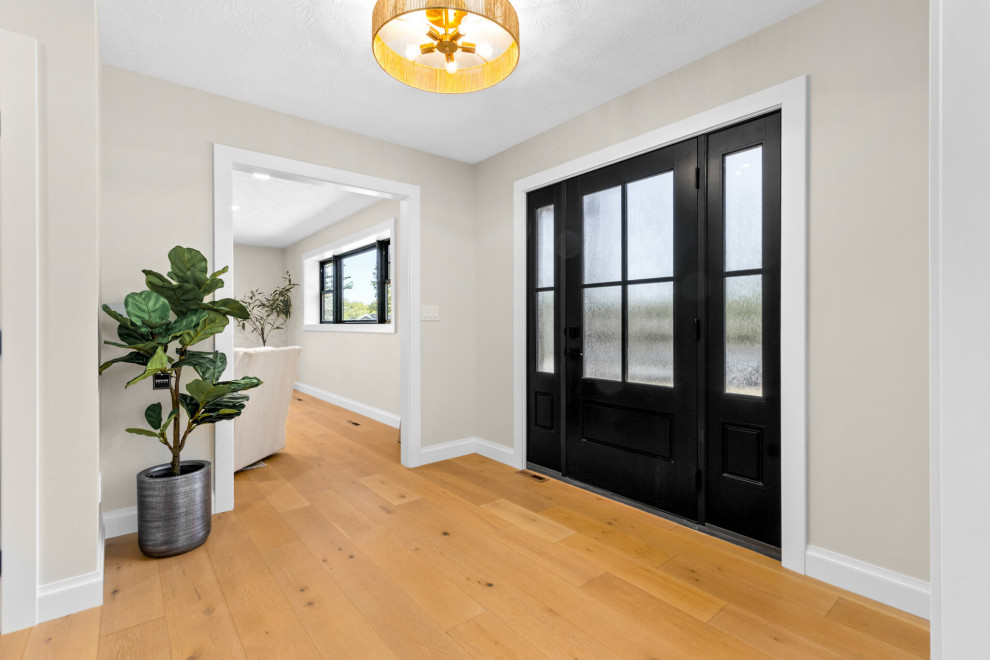 Mid-sized transitional light wood floor front door photo