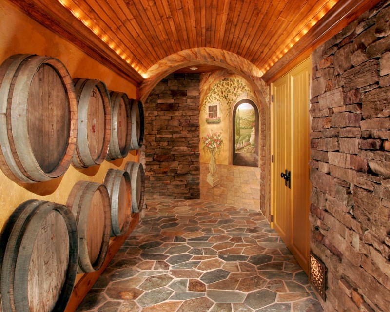 Expansive mediterranean wine cellar in Boston with slate floors and diamond bins.