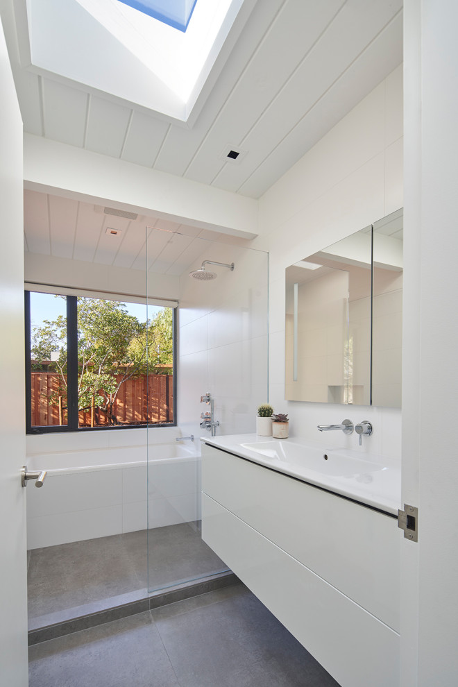 Inspiration for a large contemporary 3/4 wet room bathroom in San Francisco with flat-panel cabinets, white cabinets, an alcove tub, white walls, porcelain floors, an integrated sink, grey floor, white benchtops, a single vanity, a floating vanity and timber.