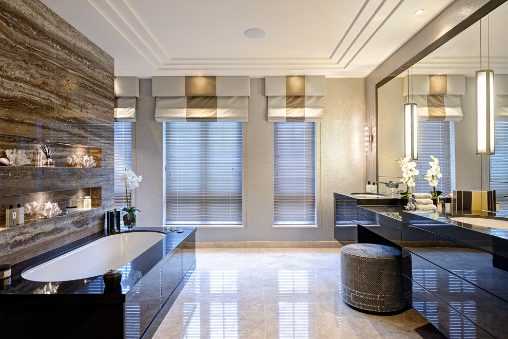 Design ideas for a contemporary master bathroom in Surrey with flat-panel cabinets, black cabinets, a drop-in tub, brown tile, beige walls, an undermount sink, beige floor and black benchtops.