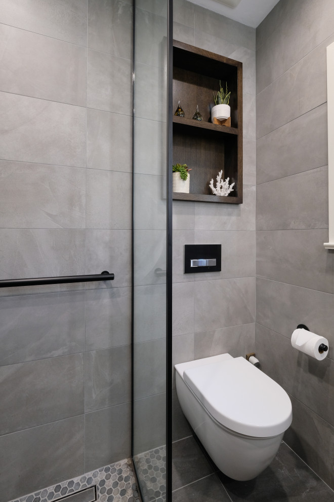 Design ideas for a mid-sized contemporary bathroom in San Diego with flat-panel cabinets, brown cabinets, a curbless shower, a wall-mount toilet, gray tile, porcelain tile, grey walls, porcelain floors, an undermount sink, engineered quartz benchtops, grey floor, an open shower, grey benchtops, a single vanity and a floating vanity.