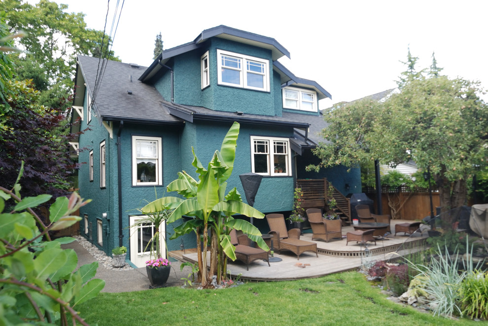 Photo of a mid-sized arts and crafts two-storey stucco blue exterior in Vancouver.