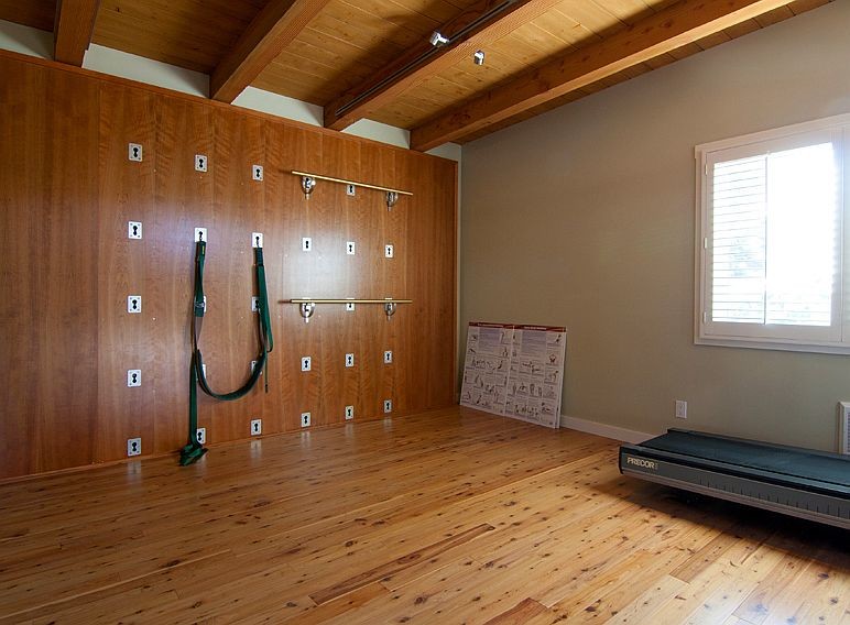 Inspiration for a small beach style home yoga studio in San Diego with green walls and light hardwood floors.