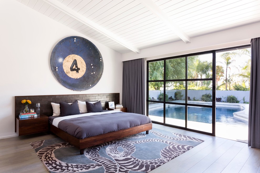Design ideas for a midcentury master bedroom in Los Angeles with white walls and light hardwood floors.