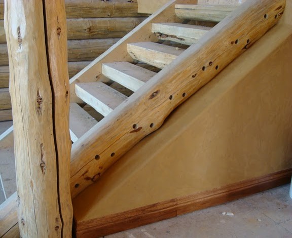 Inspiration for a rustic wooden straight open staircase remodel in Denver