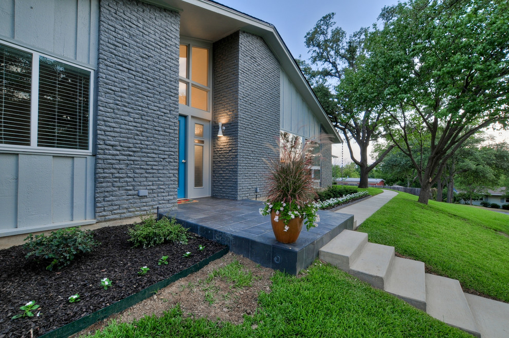Inspiration for a mid-sized midcentury one-storey brick grey exterior in Dallas with a gable roof.