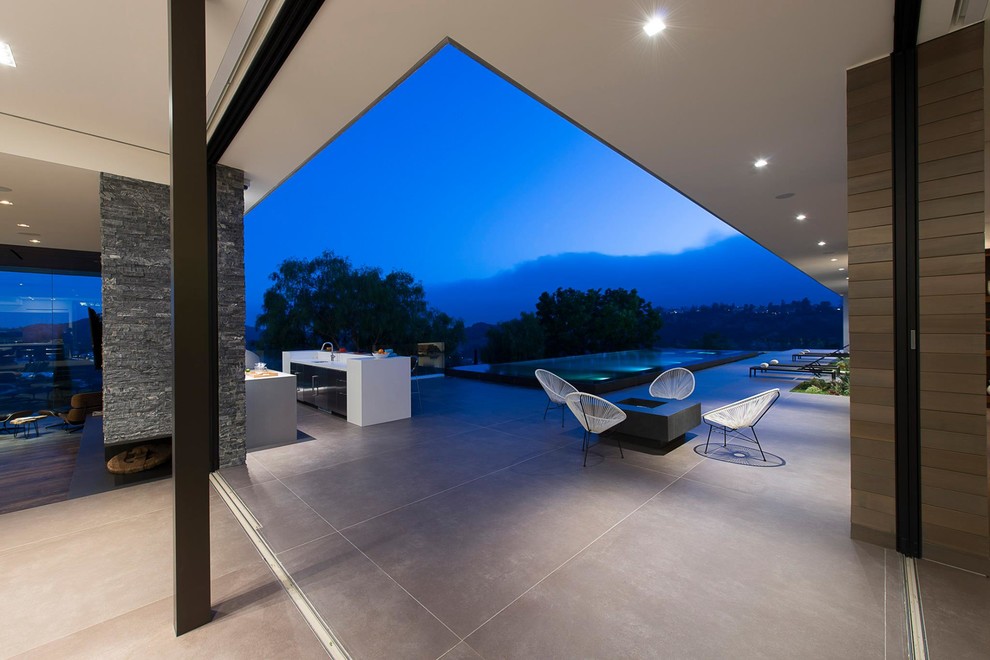 Inspiration for an expansive modern back patio in Los Angeles with an outdoor kitchen, tiled flooring and no cover.