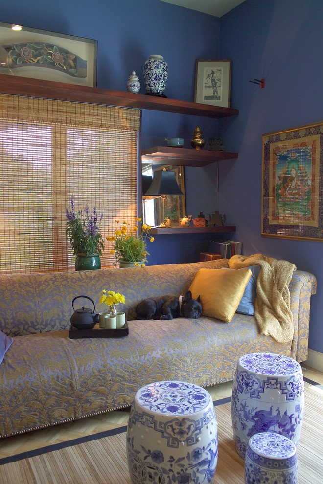 This is an example of a mid-sized asian enclosed living room in San Francisco with blue walls, medium hardwood floors, a freestanding tv and beige floor.