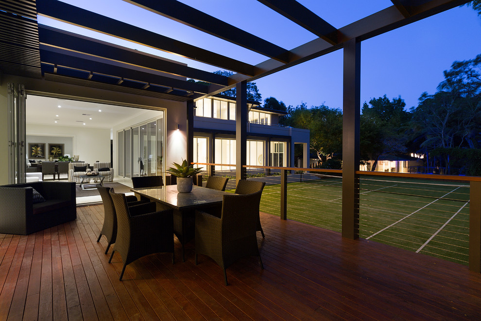 Contemporary backyard deck in Sydney with a pergola.