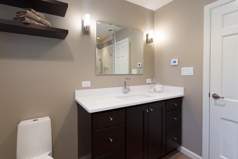 Design ideas for a mid-sized contemporary kids bathroom in New York with an undermount sink, shaker cabinets, dark wood cabinets, engineered quartz benchtops, an alcove shower, a one-piece toilet, beige tile, ceramic tile, grey walls and porcelain floors.