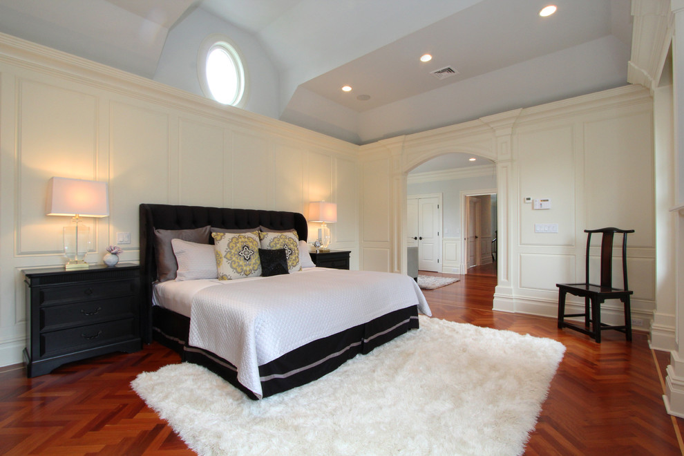Inspiration for a mid-sized transitional master bedroom in New York with white walls and medium hardwood floors.