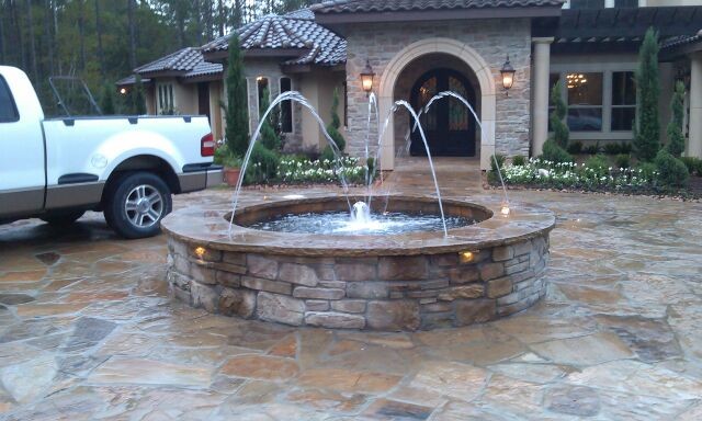 Design ideas for a large mediterranean full sun front yard stone water fountain landscape in Houston.