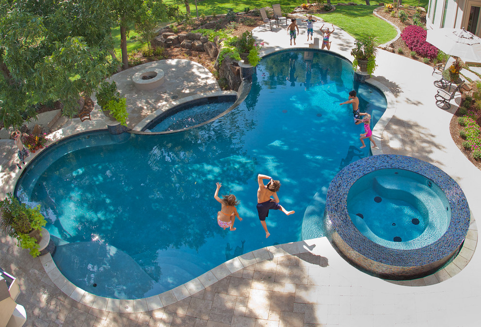 Inspiration for a large eclectic backyard custom-shaped pool in Dallas with natural stone pavers.