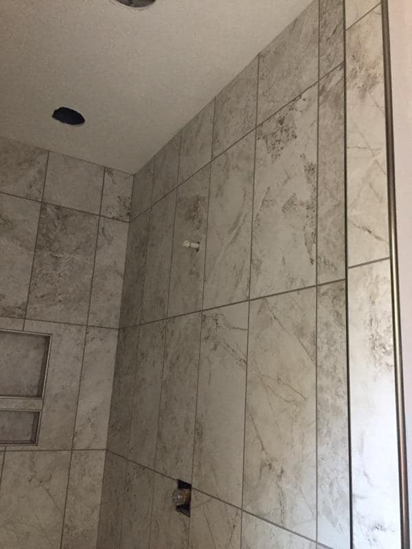 12*24 North Native Granite shower with Oasis Dark Grey master bath floor