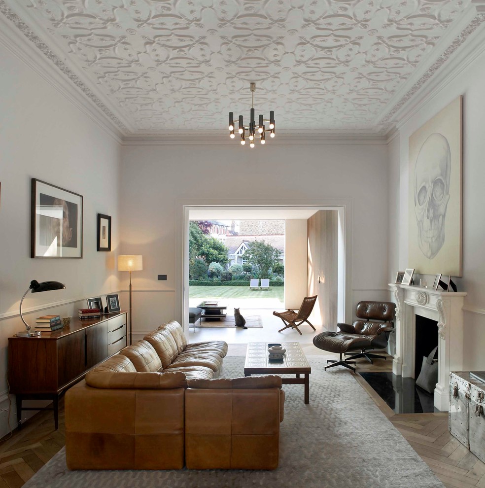 This is an example of a transitional living room in London with a standard fireplace.