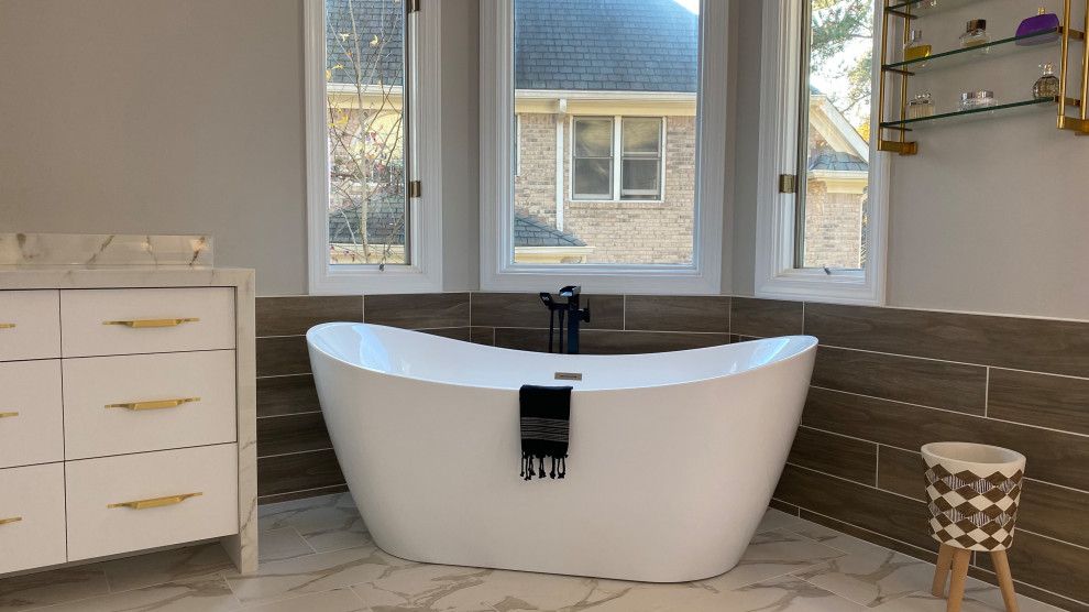 Large master porcelain tile porcelain tile and double-sink bathroom photo in Other with flat-panel cabinets, white cabinets, a two-piece toilet, beige walls, an undermount sink, tile countertops and a built-in vanity