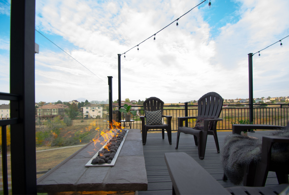 Inspiration for a mid-sized contemporary backyard and first floor deck in Denver with a fire feature, no cover and metal railing.