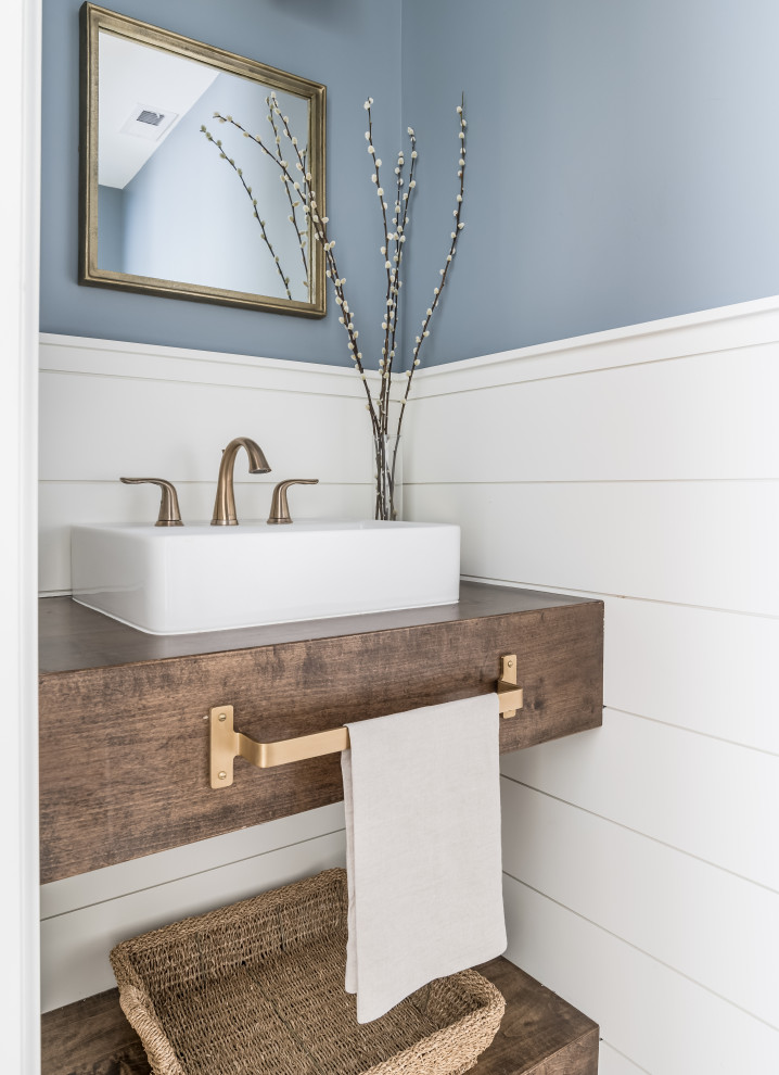 Inspiration for a small beach style powder room in Nashville with blue walls, wood benchtops, a floating vanity, planked wall panelling, dark wood cabinets and a vessel sink.