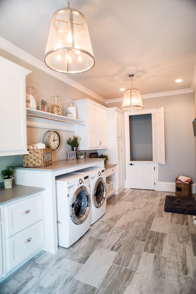 Photo of a large traditional laundry room in Atlanta with plywood floors and grey walls.