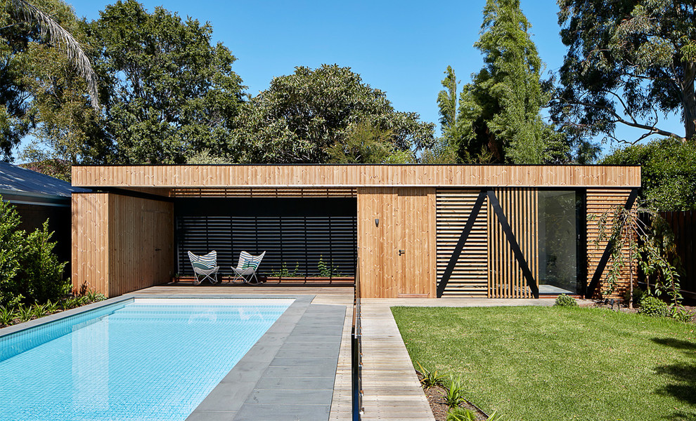 Photo of a contemporary one-storey brown house exterior in Melbourne with wood siding and a flat roof.