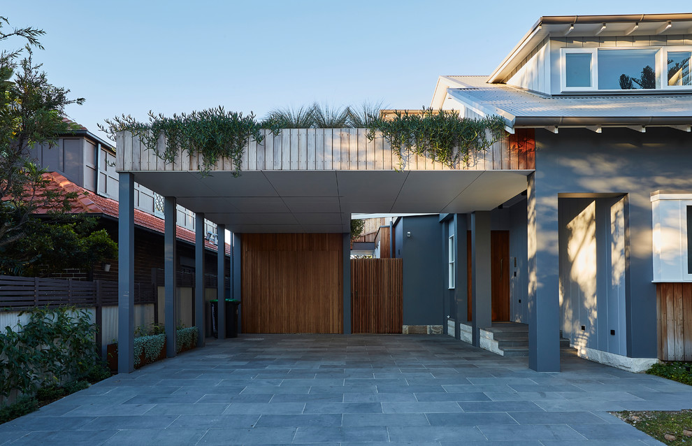 This is an example of a mid-sized contemporary attached two-car carport in Sydney.