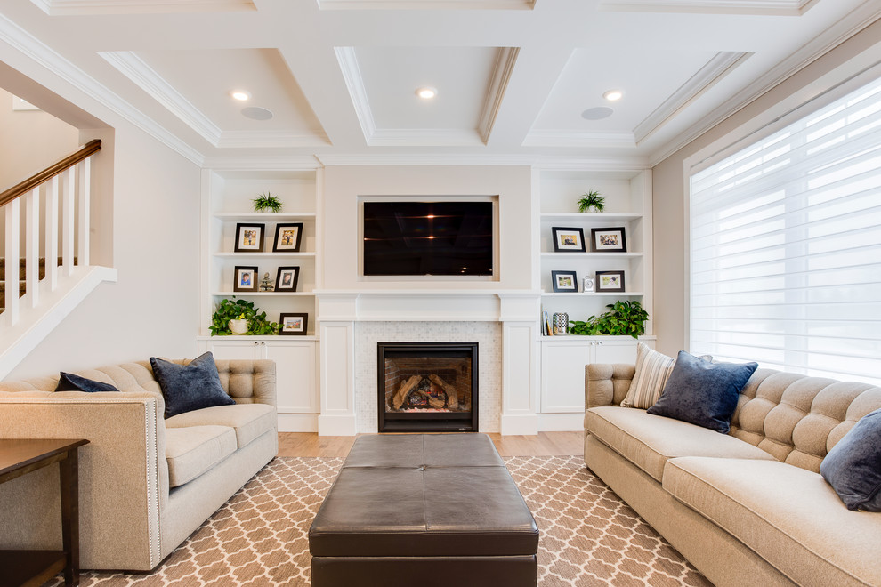 Inspiration for a transitional living room in Other with light hardwood floors, a standard fireplace, a tile fireplace surround and a built-in media wall.