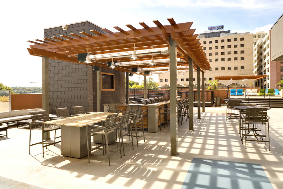 This is an example of a courtyard patio in Minneapolis with a pergola.