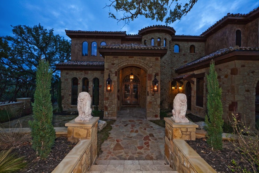 Large traditional two-storey beige exterior in Houston with stone veneer.