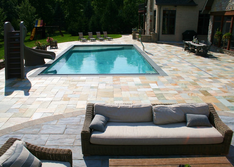 Photo of a large traditional rectangular pool in Other with tile.