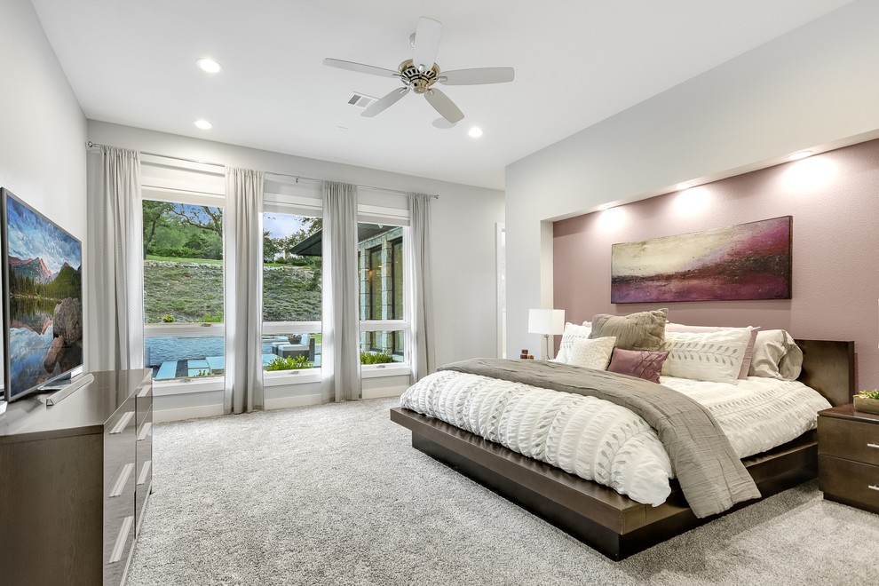 This is an example of a transitional bedroom in Austin.