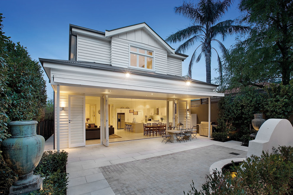 Design ideas for a traditional two-storey white exterior in Melbourne with wood siding.