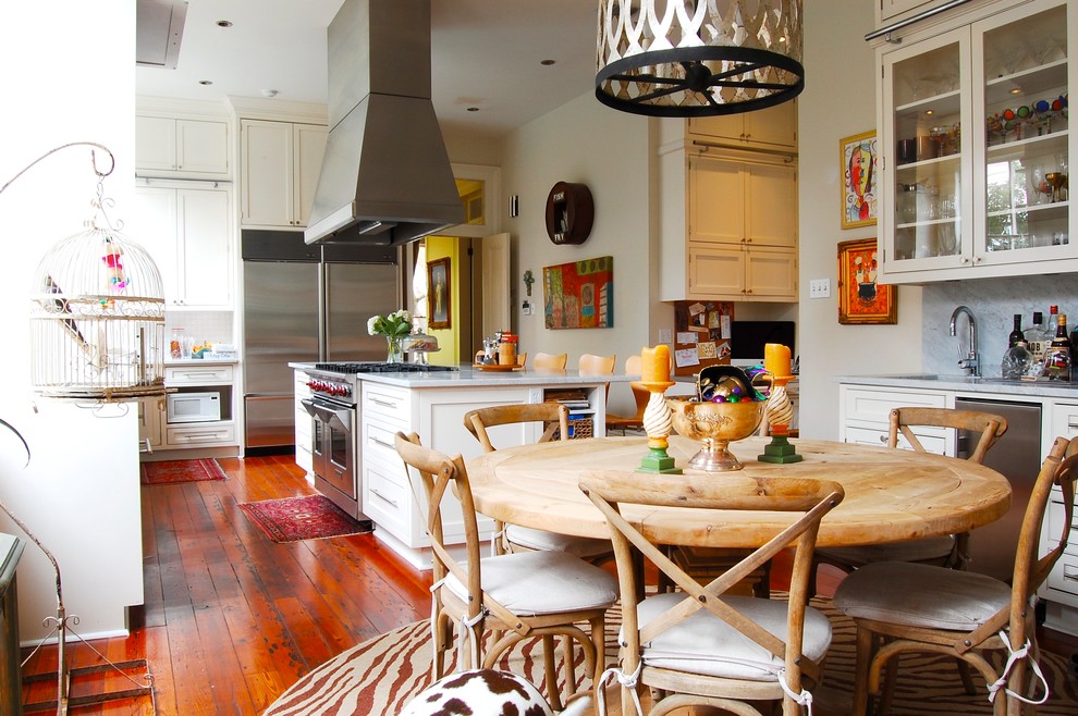 Inspiration for an eclectic eat-in kitchen in New York with shaker cabinets, white cabinets and stainless steel appliances.