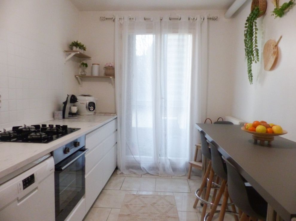 This is an example of a medium sized traditional single-wall enclosed kitchen in Marseille with a single-bowl sink, beaded cabinets, white cabinets, marble worktops, white splashback, matchstick tiled splashback, integrated appliances, cement flooring, beige floors and white worktops.