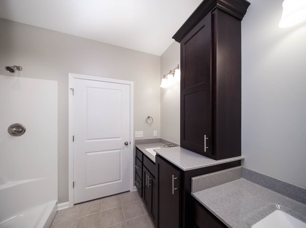 Inspiration for a mid-sized transitional master gray tile and ceramic tile ceramic tile bathroom remodel in Chicago with a drop-in sink, flat-panel cabinets, dark wood cabinets, quartzite countertops, a one-piece toilet and gray walls