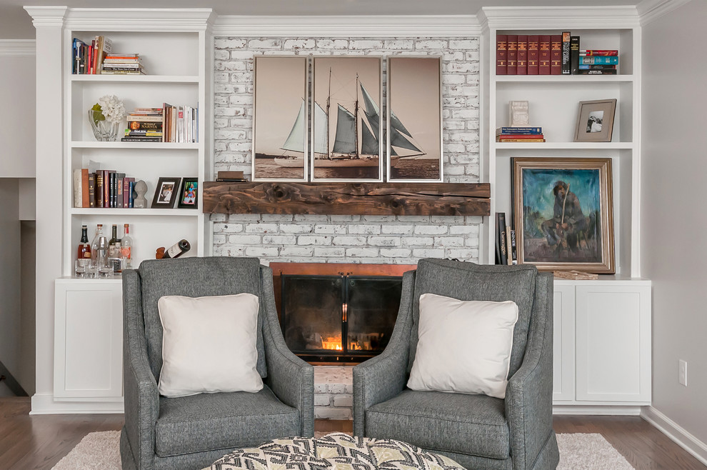 Design ideas for a beach style living room in Atlanta with a library and a standard fireplace.