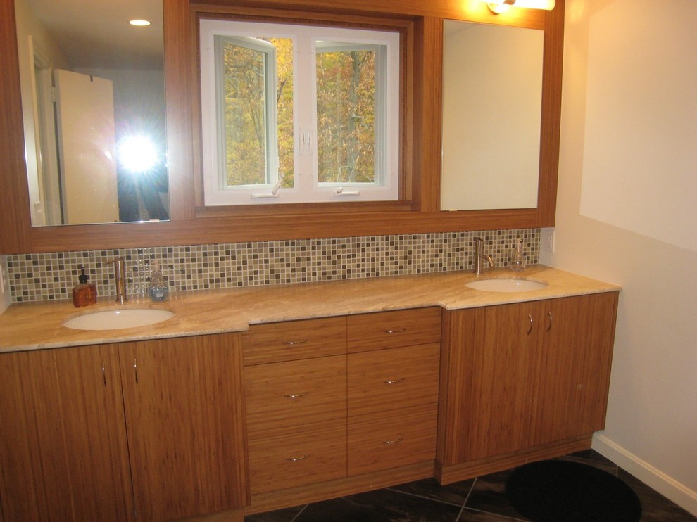 Inspiration for a mid-sized transitional master beige tile and pebble tile alcove shower remodel in Boston with flat-panel cabinets, medium tone wood cabinets, a two-piece toilet, white walls, an undermount sink and granite countertops
