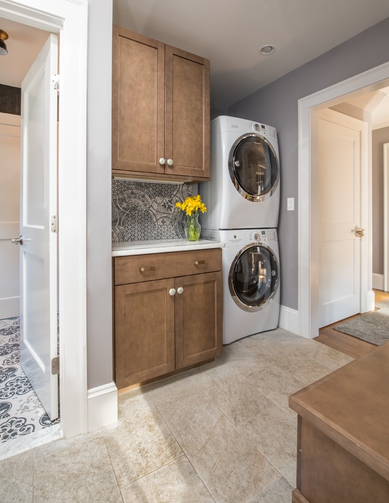 Design ideas for a mid-sized transitional utility room in Boston with grey walls, beige floor, quartz benchtops, a side-by-side washer and dryer, shaker cabinets, medium wood cabinets and porcelain floors.