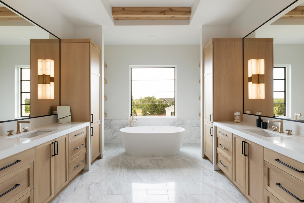 This is an example of a traditional ensuite bathroom in Minneapolis with a freestanding bath, grey tiles, marble tiles, white walls, marble flooring, engineered stone worktops, grey floors, a hinged door, white worktops, an enclosed toilet, double sinks, a built in vanity unit and exposed beams.