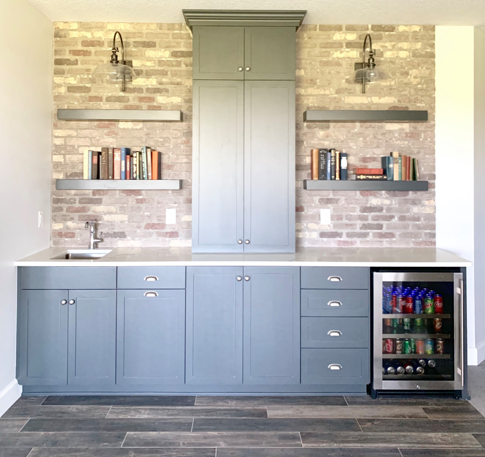 Large country wet bar in Other with an undermount sink, shaker cabinets, grey cabinets, quartz benchtops, brick splashback and white benchtop.